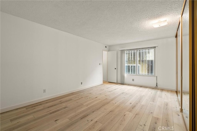 8740 Tuscany Ave Unit 109, Playa Del Rey, CA 90293 - empty room featuring light wood-style floors and a textured ceiling