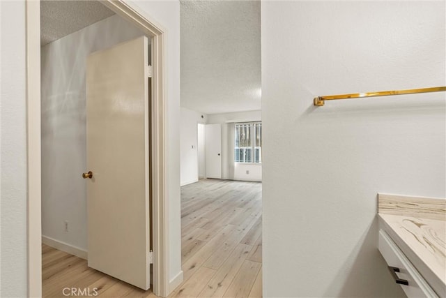 bathroom with hardwood / wood-style floors and a textured ceiling