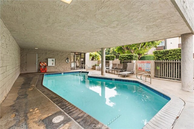 view of swimming pool with a patio