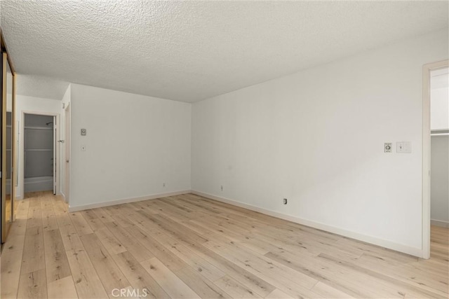 8740 Tuscany Ave Unit 109, Playa Del Rey, CA 90293 - spare room featuring light wood finished floors, baseboards, and a textured ceiling
