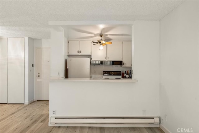 kitchen featuring white refrigerator, range with electric cooktop, white cabinets, and light hardwood / wood-style floors