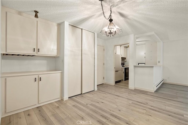 8740 Tuscany Ave Unit 109, Playa Del Rey, CA 90293 - unfurnished dining area with a textured ceiling, a chandelier, a baseboard heating unit, and light wood-type flooring