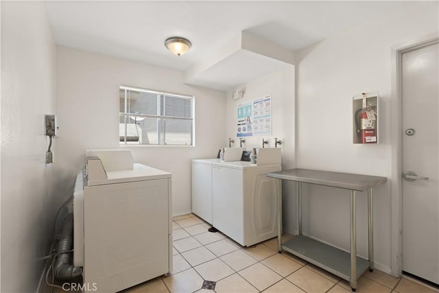 8740 Tuscany Ave Unit 109, Playa Del Rey, CA 90293 - shared laundry featuring washing machine and dryer and light tile patterned flooring