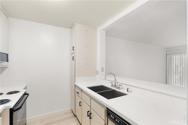 8740 Tuscany Ave Unit 109, Playa Del Rey, CA 90293 - kitchen with range with electric stovetop, light wood-type flooring, and light countertops