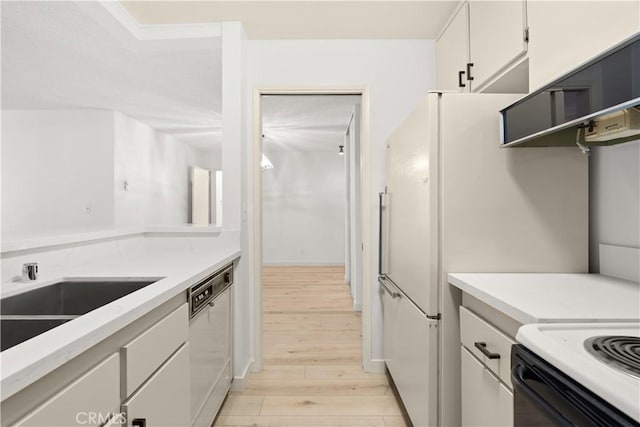 8740 Tuscany Ave Unit 109, Playa Del Rey, CA 90293 - kitchen with dishwasher, light wood finished floors, light countertops, white cabinets, and a sink