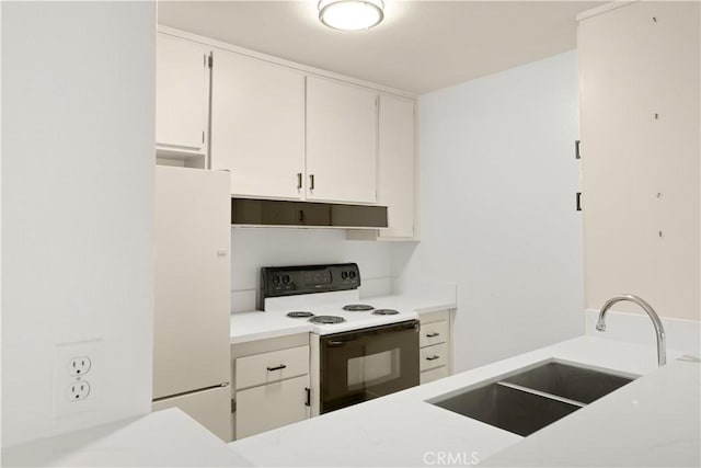 8740 Tuscany Ave Unit 109, Playa Del Rey, CA 90293 - kitchen with electric range, freestanding refrigerator, a sink, light countertops, and white cabinetry
