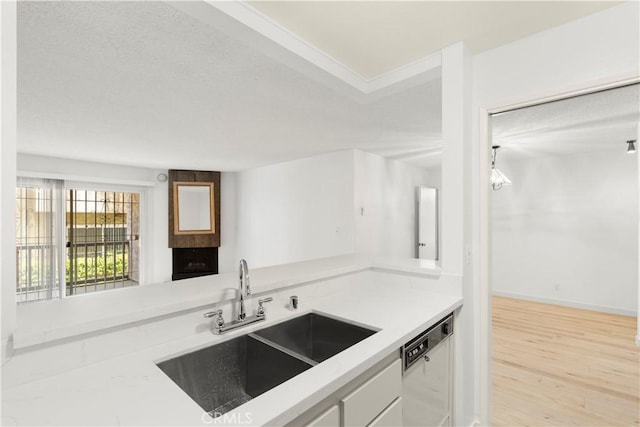 8740 Tuscany Ave Unit 109, Playa Del Rey, CA 90293 - kitchen featuring dishwashing machine, wood finished floors, light countertops, and white cabinets