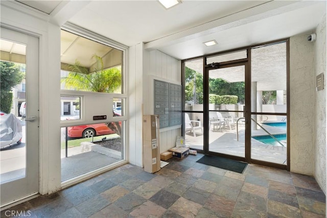 8740 Tuscany Ave Unit 109, Playa Del Rey, CA 90293 - doorway featuring stone tile floors and expansive windows