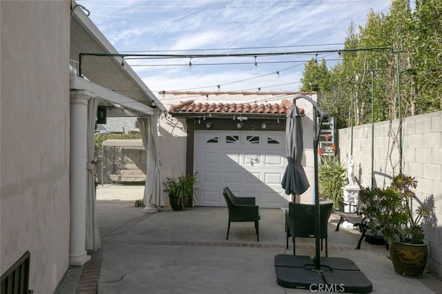 view of patio featuring a garage