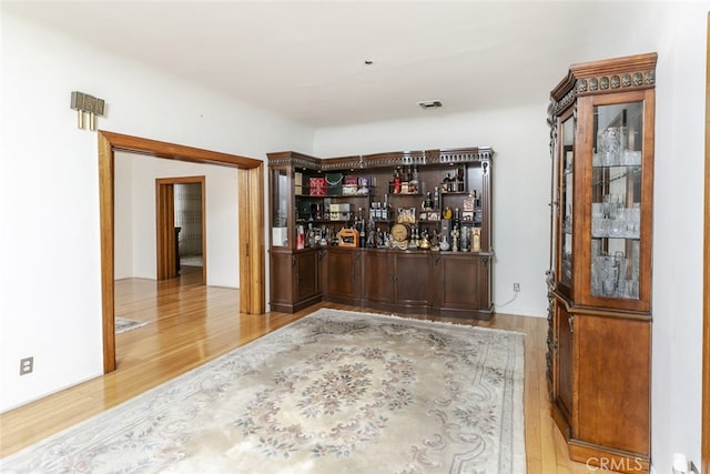 bar with hardwood / wood-style floors