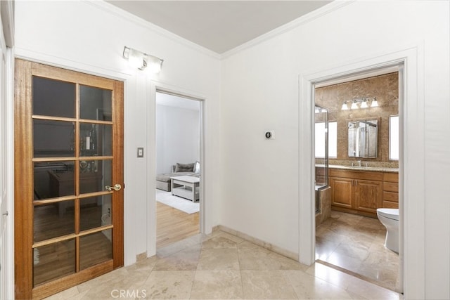 hall with ornamental molding and sink