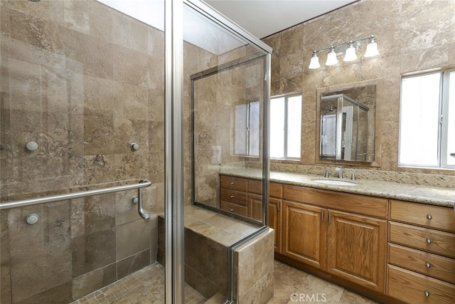 bathroom featuring vanity and a shower with shower door