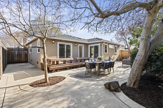 rear view of property with a patio and a deck