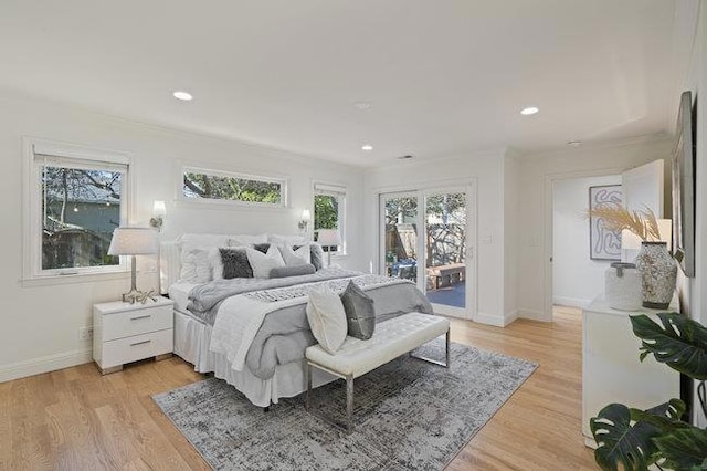 bedroom featuring multiple windows, access to exterior, and light hardwood / wood-style flooring