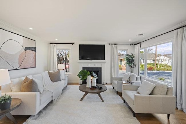 living room featuring light hardwood / wood-style flooring and ornamental molding