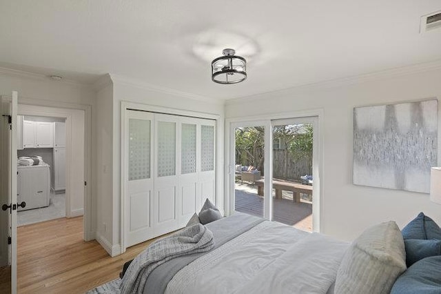 bedroom with crown molding, light hardwood / wood-style flooring, access to outside, a closet, and washer / clothes dryer