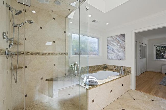 bathroom with tile patterned flooring, ornamental molding, and shower with separate bathtub