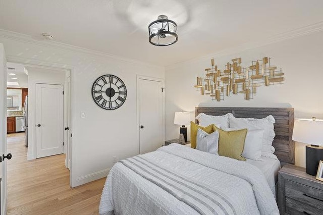 bedroom featuring ornamental molding and light wood-type flooring