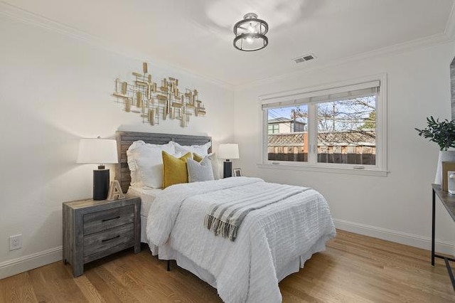 bedroom featuring wood-type flooring and ornamental molding