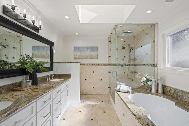 bathroom with tile patterned flooring, tile walls, vanity, ornamental molding, and plus walk in shower