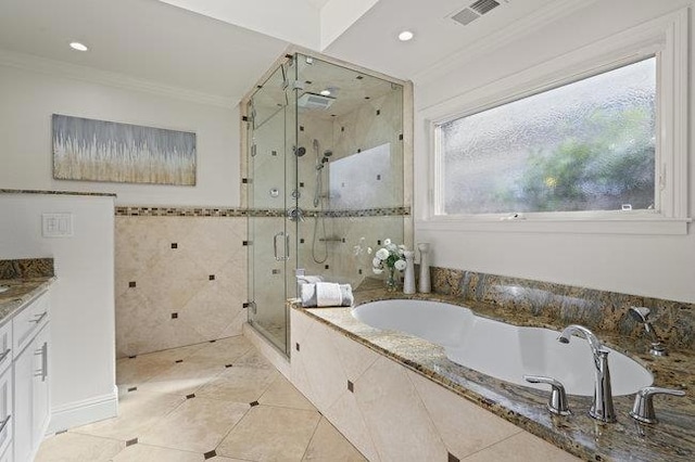 bathroom with tile patterned floors, crown molding, tile walls, vanity, and independent shower and bath