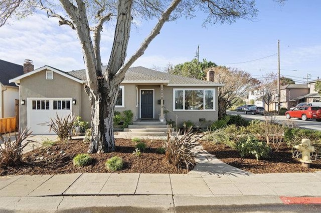 bungalow featuring a garage