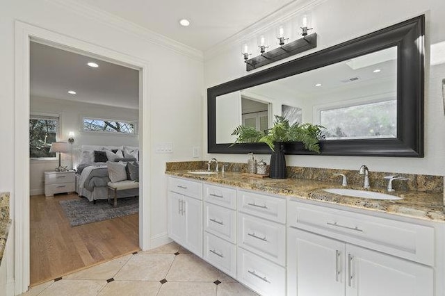 bathroom featuring crown molding, vanity, and tile patterned flooring