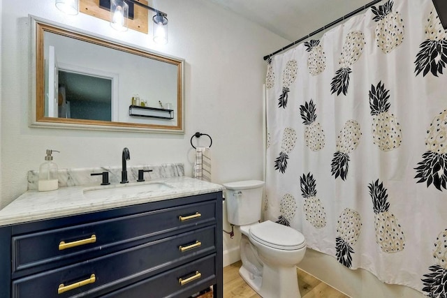 full bathroom featuring shower / tub combo with curtain, wood-type flooring, toilet, and vanity