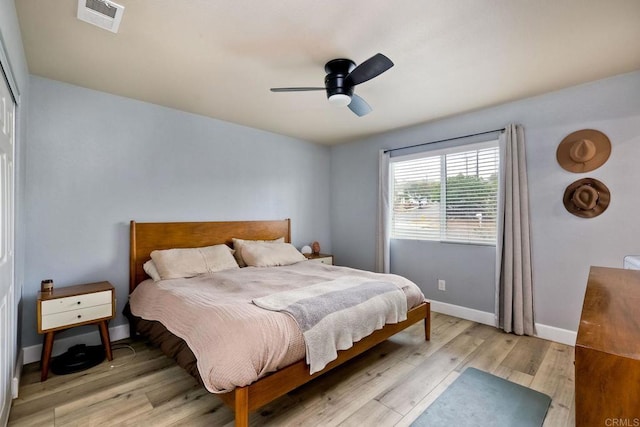 bedroom featuring ceiling fan, light hardwood / wood-style floors, and a closet