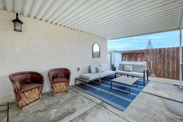 view of patio / terrace featuring outdoor lounge area and a storage unit