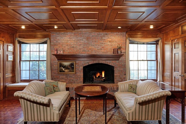 sitting room with a brick fireplace, wooden walls, and brick wall