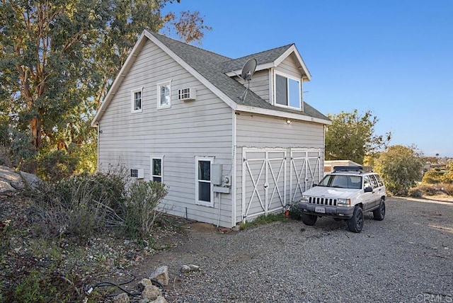 view of side of property with a wall mounted AC