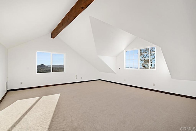 additional living space featuring light carpet, vaulted ceiling with beams, and a wealth of natural light