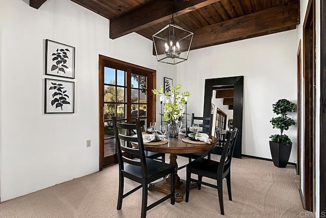 carpeted dining space featuring an inviting chandelier, wooden ceiling, and beamed ceiling