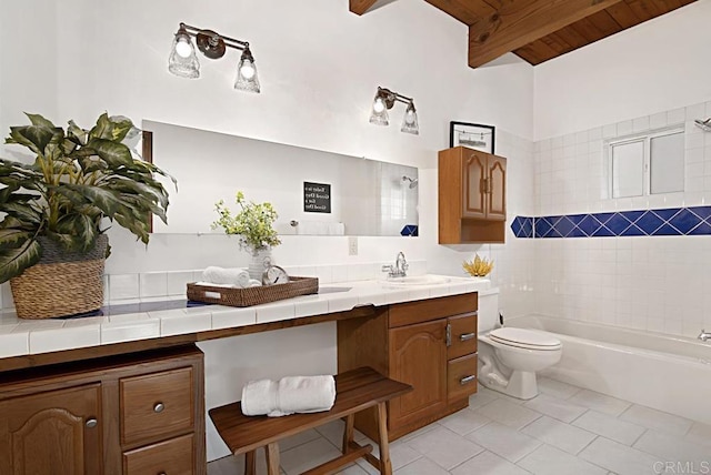 bathroom featuring tile patterned flooring, vanity, beam ceiling, and toilet