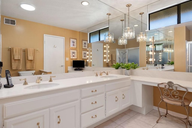 bathroom with an enclosed shower, vanity, tile patterned floors, and toilet