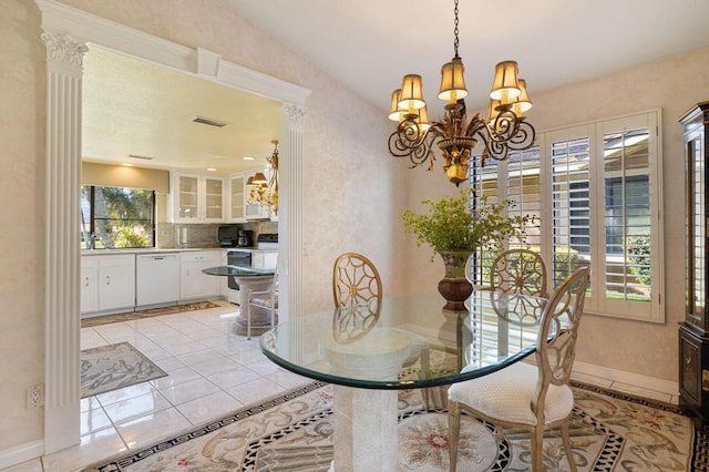 tiled dining area featuring a chandelier