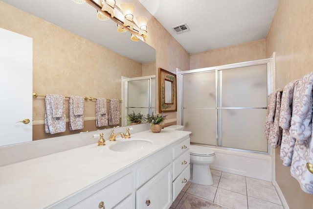 full bathroom featuring enclosed tub / shower combo, tile patterned floors, toilet, and vanity