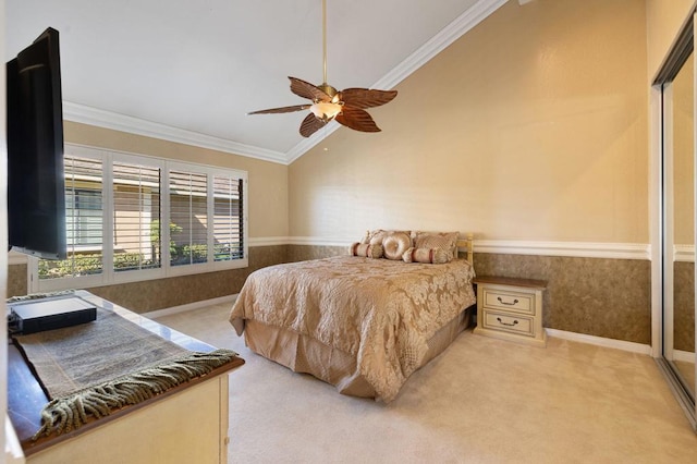 bedroom featuring ornamental molding, lofted ceiling, light colored carpet, and ceiling fan