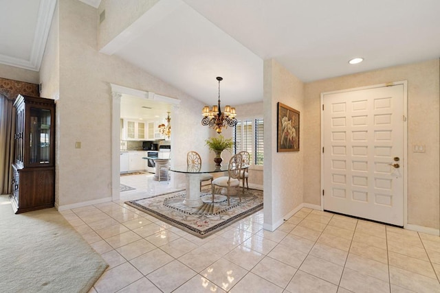 foyer entrance with light tile patterned flooring, lofted ceiling, and a notable chandelier