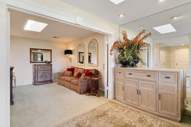 carpeted living room with a skylight