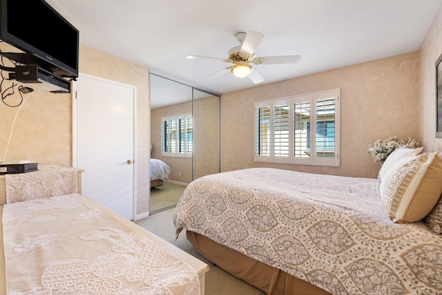 bedroom featuring ceiling fan, a closet, and light carpet