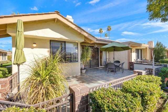 back of property with a patio