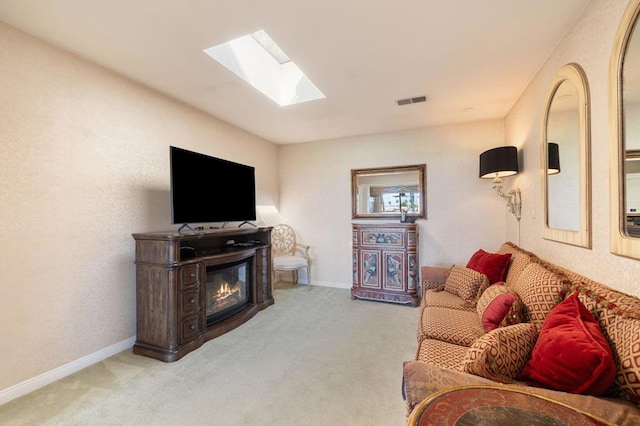 carpeted living room with a skylight