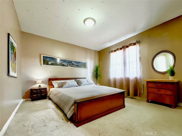 carpeted bedroom with lofted ceiling