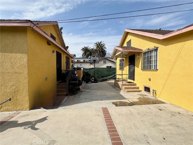 view of side of home featuring a patio area