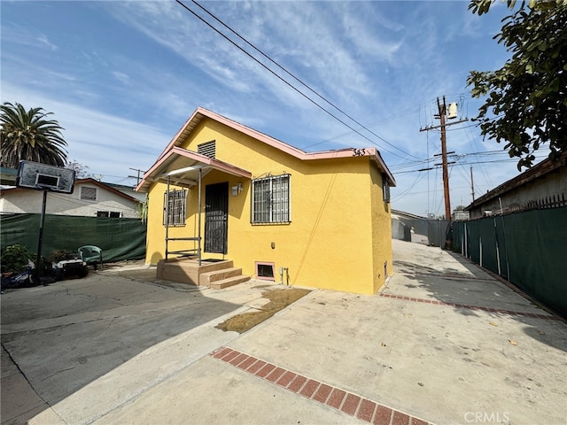 bungalow-style home with a patio