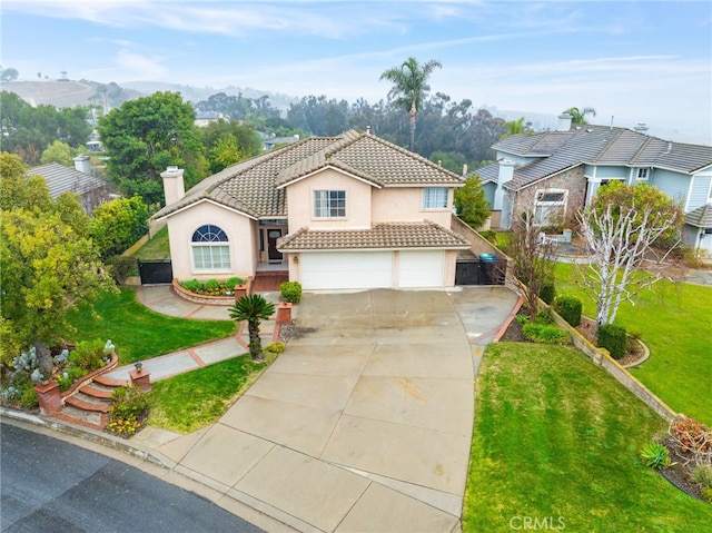 mediterranean / spanish-style home with a garage and a front lawn