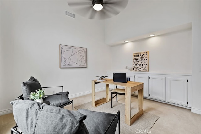 office space with light carpet and ceiling fan