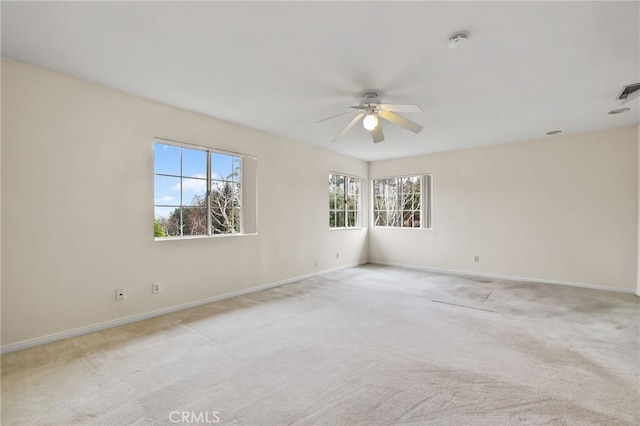 unfurnished room with light colored carpet and ceiling fan